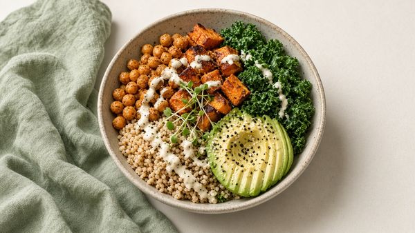 Plant-forward bowl with roasted chickpeas, sweet potato, kale, avocado and tahini