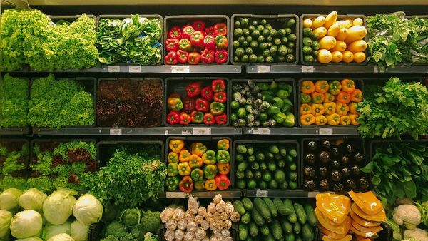 A grocery store produce aisle stocked with fruits and vegetables