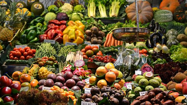 A market stall piled with fresh fruits and vegetables