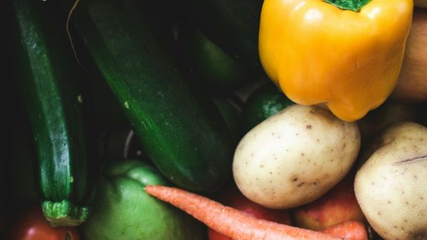Close-up of potatoes, a yellow pepper, zucchini, and carrots